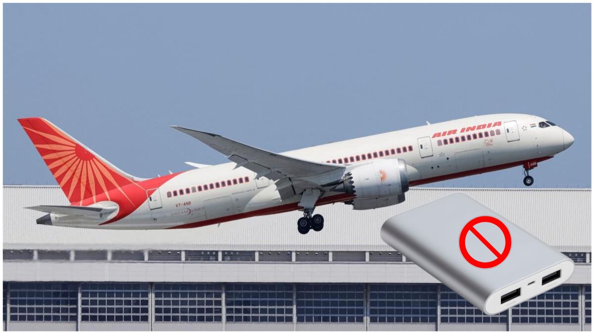 एयरलाइन कैबिन में यात्री के हाथ में पावर बैंक, चार्जिंग निषिद्ध का संकेत, हवाई यात्रा सुरक्षा और इलेक्ट्रॉनिक डिवाइस के जोखिम को दर्शाता दृश्य